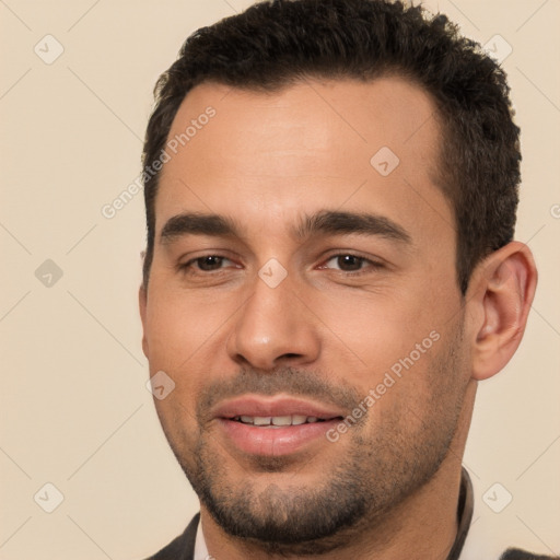 Joyful white young-adult male with short  black hair and brown eyes