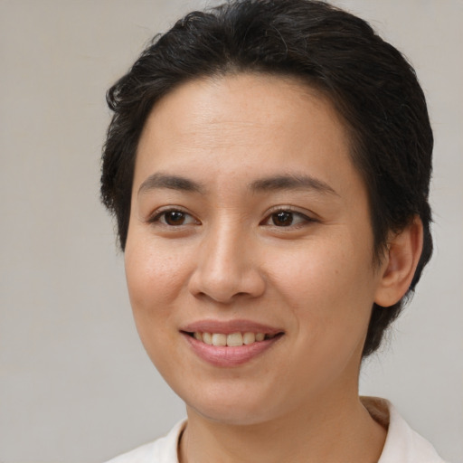 Joyful white young-adult female with short  brown hair and brown eyes
