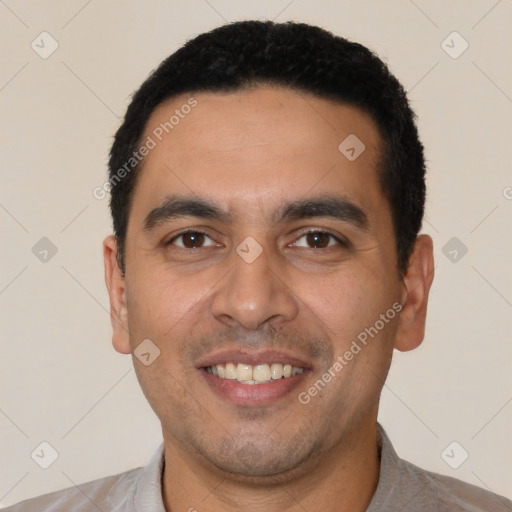 Joyful latino young-adult male with short  black hair and brown eyes