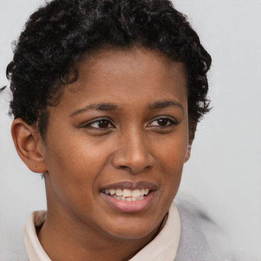 Joyful black young-adult female with short  brown hair and brown eyes