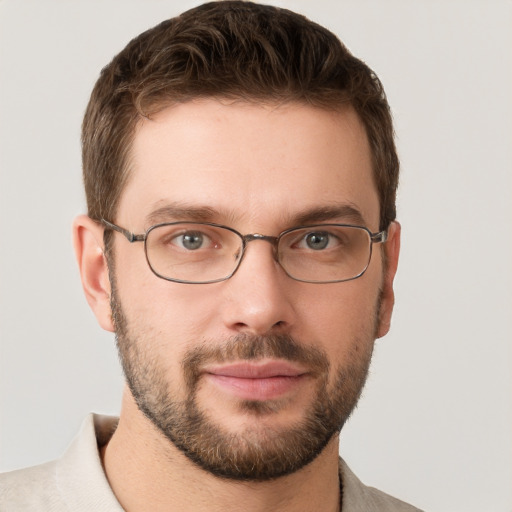 Joyful white young-adult male with short  brown hair and grey eyes