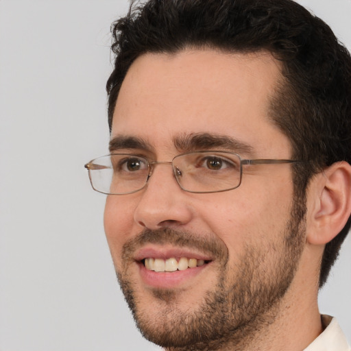 Joyful white adult male with short  brown hair and brown eyes