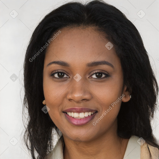 Joyful black young-adult female with long  black hair and brown eyes