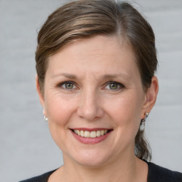 Joyful white adult female with short  brown hair and grey eyes