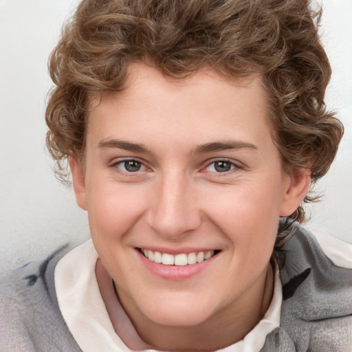 Joyful white young-adult female with short  brown hair and blue eyes