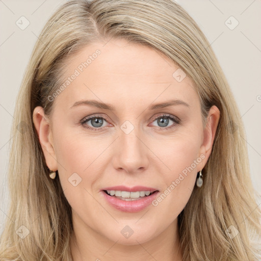 Joyful white young-adult female with long  brown hair and blue eyes