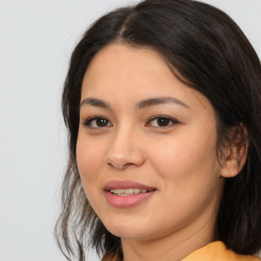 Joyful asian young-adult female with long  brown hair and brown eyes