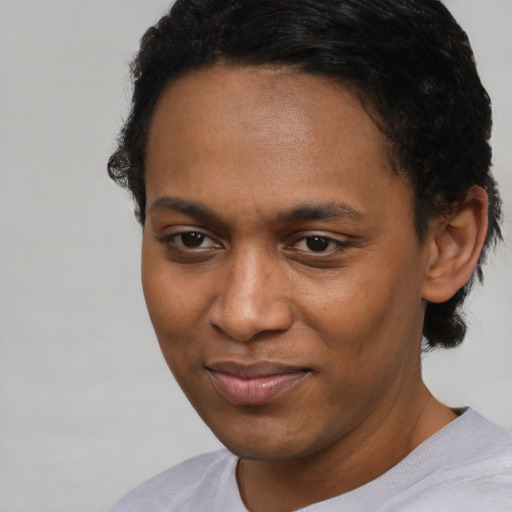 Joyful black young-adult male with short  brown hair and brown eyes
