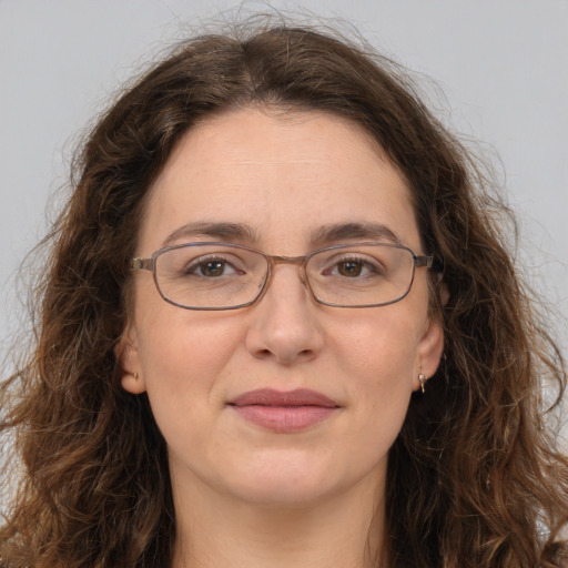 Joyful white adult female with long  brown hair and green eyes