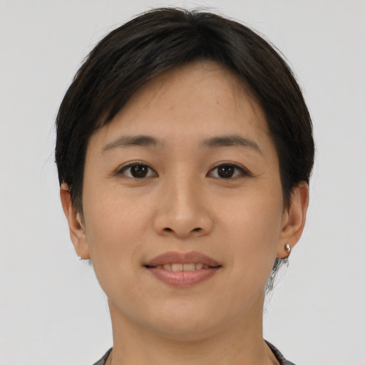 Joyful asian young-adult female with short  brown hair and brown eyes
