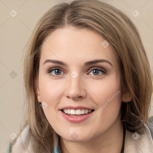 Joyful white young-adult female with long  brown hair and green eyes