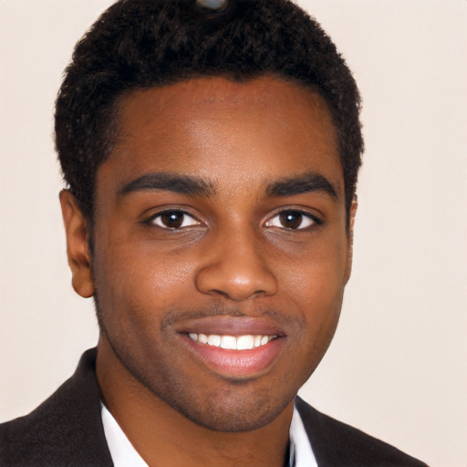 Joyful black young-adult male with short  black hair and brown eyes