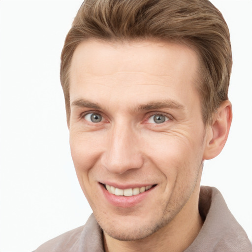 Joyful white young-adult male with short  brown hair and grey eyes