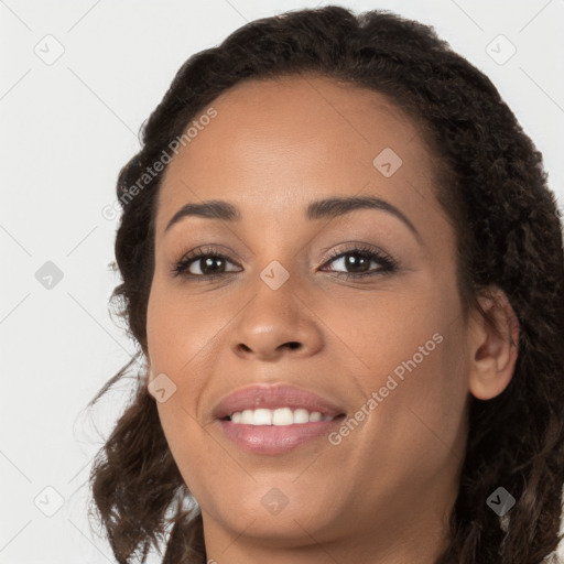 Joyful latino young-adult female with long  brown hair and brown eyes