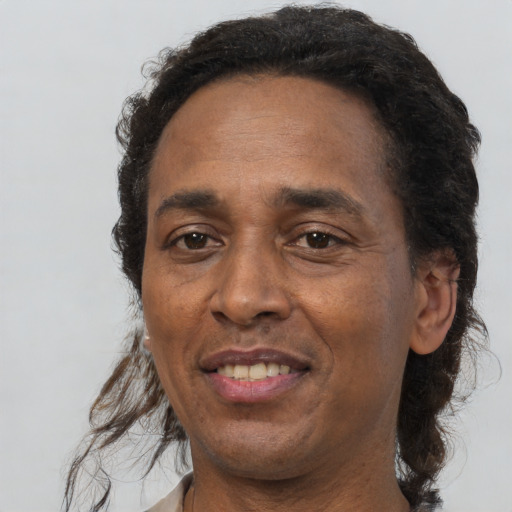 Joyful black adult male with short  brown hair and brown eyes
