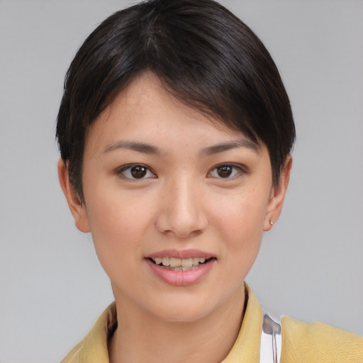 Joyful asian young-adult female with short  brown hair and brown eyes