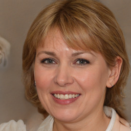 Joyful white adult female with medium  brown hair and blue eyes