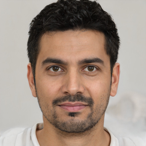 Joyful white young-adult male with short  black hair and brown eyes