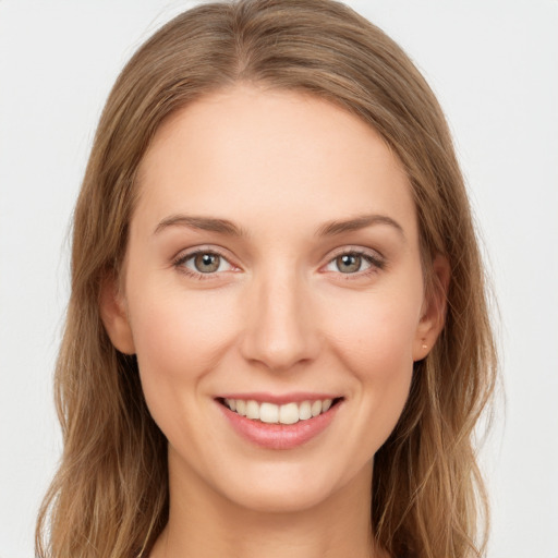 Joyful white young-adult female with long  brown hair and green eyes