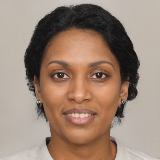 Joyful black adult female with medium  black hair and brown eyes