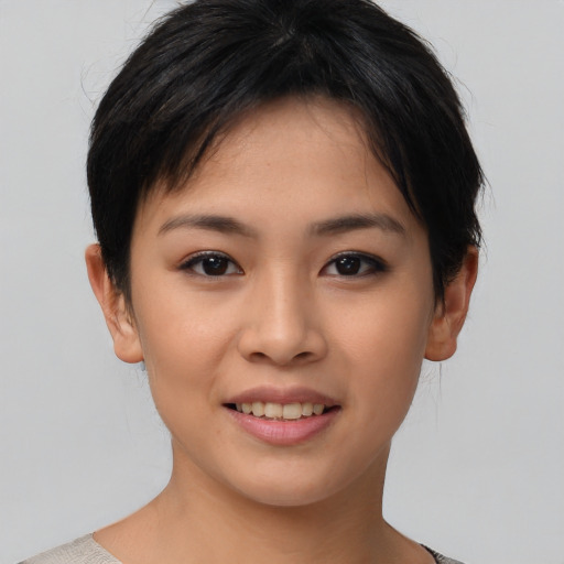 Joyful asian young-adult female with short  brown hair and brown eyes