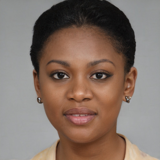 Joyful black young-adult female with short  brown hair and brown eyes
