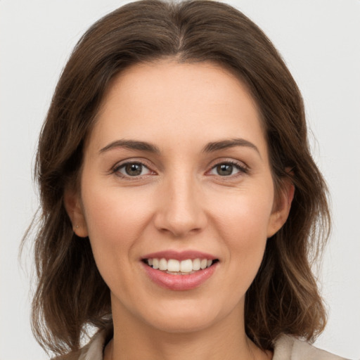 Joyful white young-adult female with medium  brown hair and brown eyes