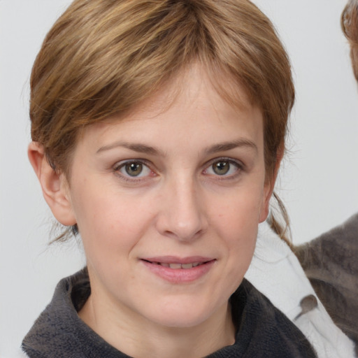 Joyful white young-adult female with medium  brown hair and grey eyes