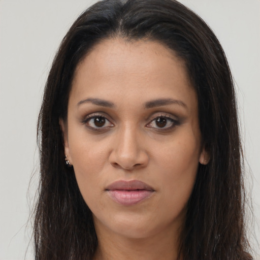 Joyful latino young-adult female with long  brown hair and brown eyes
