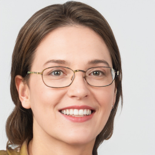 Joyful white adult female with medium  brown hair and blue eyes