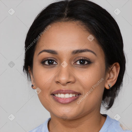 Joyful latino young-adult female with medium  brown hair and brown eyes