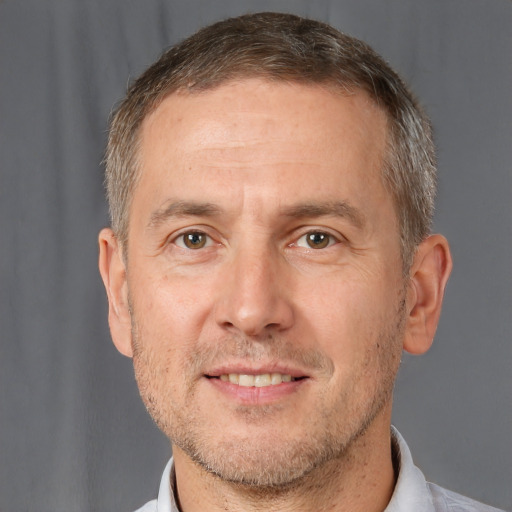 Joyful white adult male with short  brown hair and brown eyes