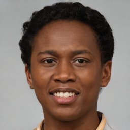 Joyful latino young-adult male with short  brown hair and brown eyes