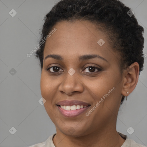 Joyful black young-adult female with short  brown hair and brown eyes