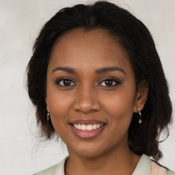 Joyful black young-adult female with medium  brown hair and brown eyes