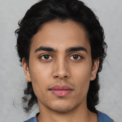 Neutral latino young-adult male with medium  black hair and brown eyes