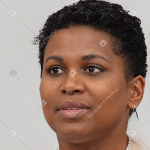 Joyful black young-adult female with short  black hair and brown eyes