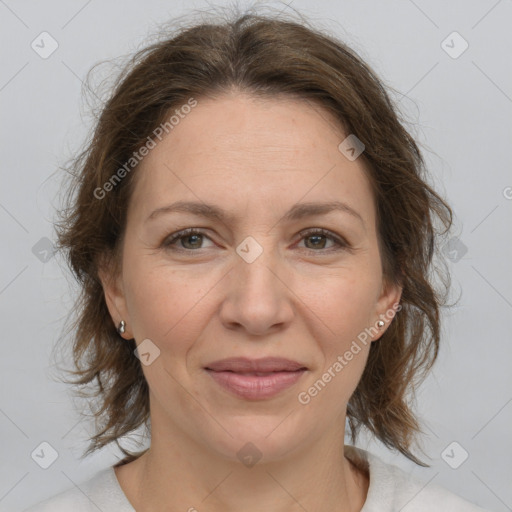 Joyful white adult female with medium  brown hair and grey eyes