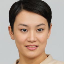 Joyful asian young-adult female with short  brown hair and brown eyes