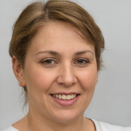 Joyful white adult female with medium  brown hair and brown eyes