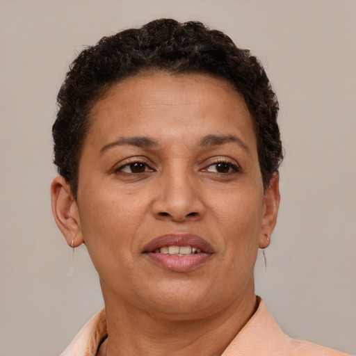 Joyful latino adult female with short  brown hair and brown eyes