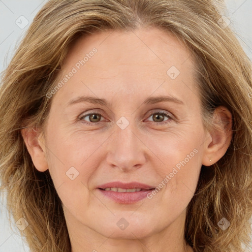 Joyful white adult female with long  brown hair and brown eyes