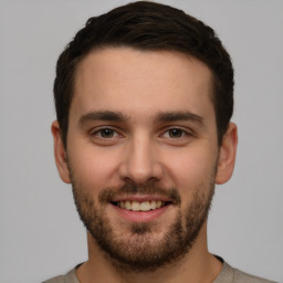 Joyful white young-adult male with short  brown hair and brown eyes