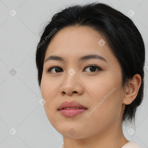 Joyful asian young-adult female with medium  brown hair and brown eyes