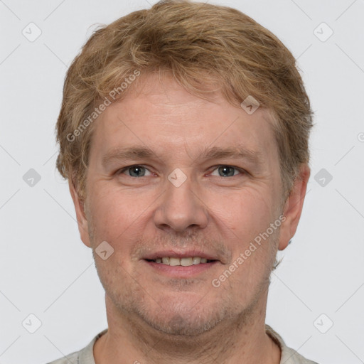 Joyful white adult male with short  brown hair and grey eyes