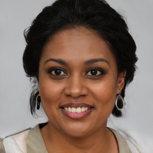 Joyful black young-adult female with medium  black hair and brown eyes