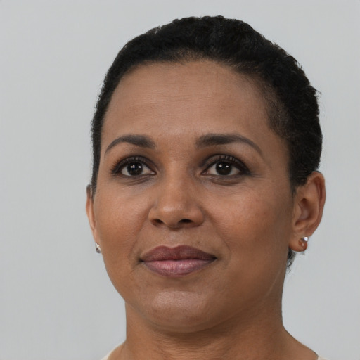 Joyful black adult female with short  black hair and brown eyes
