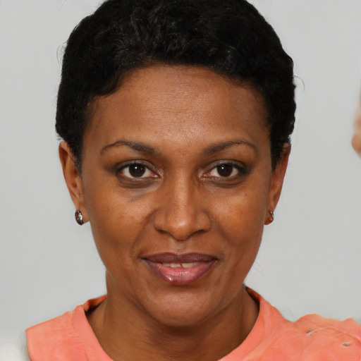 Joyful black young-adult female with short  black hair and brown eyes