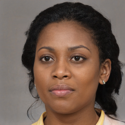 Joyful black young-adult female with medium  black hair and brown eyes