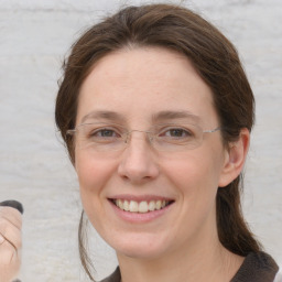 Joyful white adult female with medium  brown hair and grey eyes